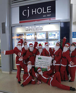 CJ hole with people dressed as father Christmas 