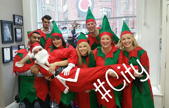 people dressed in elf outfits with #city over the photo 