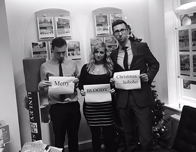 black and white photo with 3 people holding up signs 