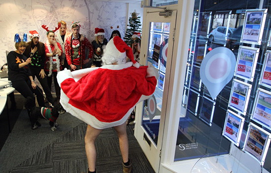 father Christmas showing the office his front bottom 