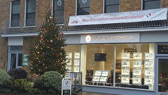 Christmas tree outside in front of a estate agent 