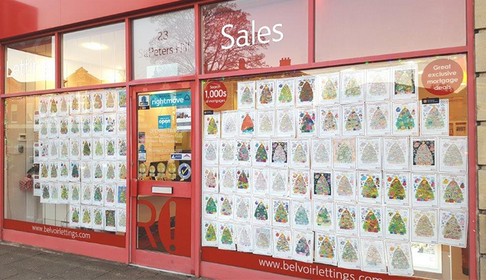 letting agent with Christmas cards on the front window 