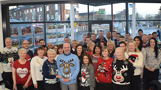 Christmas jumpers group photo lots of peopel