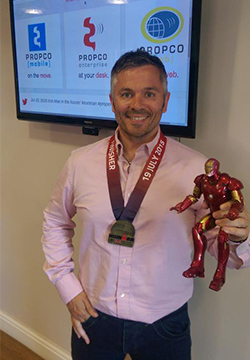 man with medal and iron man toy