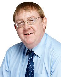 man in blue shirt with glasses and a tie on 